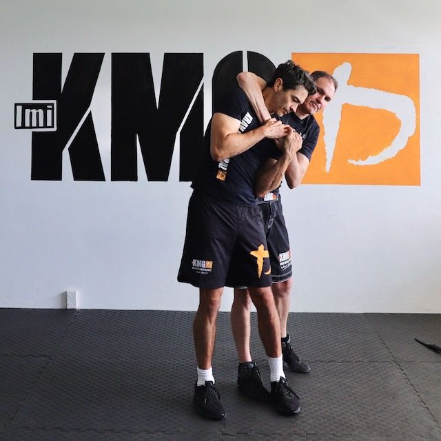 Self-defence training example showing a close-range headlock defence scenario