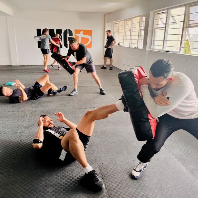 Krav Maga Auckland student working ground defences during training at KMG North Shore, Birkenhead — stress-based scenario work at 47 Birkenhead Avenue