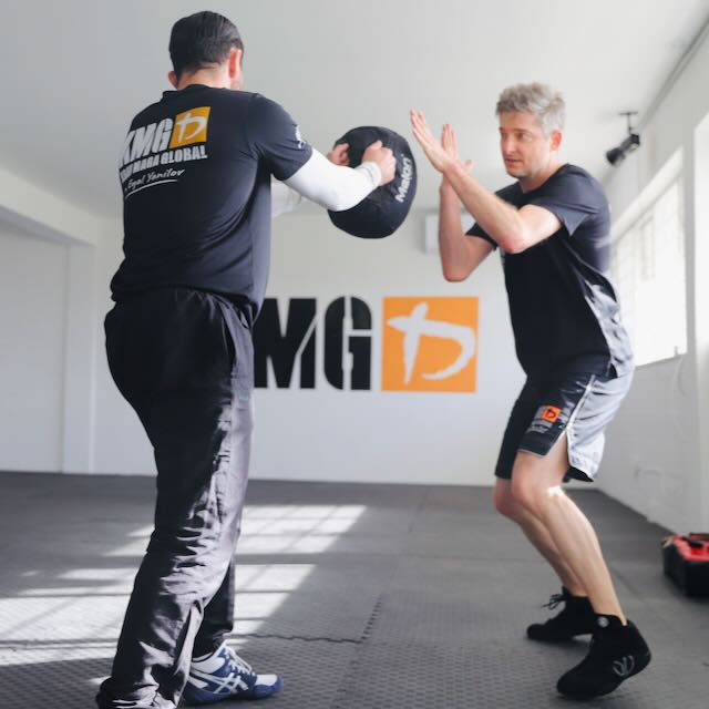 Student practising a strike on focus pad at Krav Maga Auckland, Birkenhead