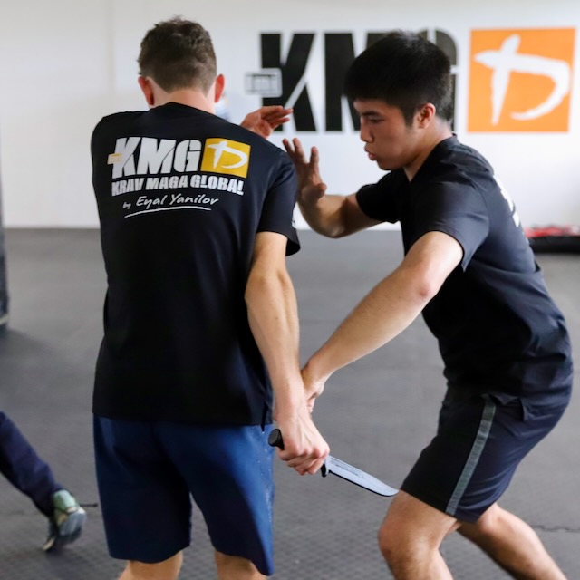 KMG New Zealand students drilling knife defence responses during training