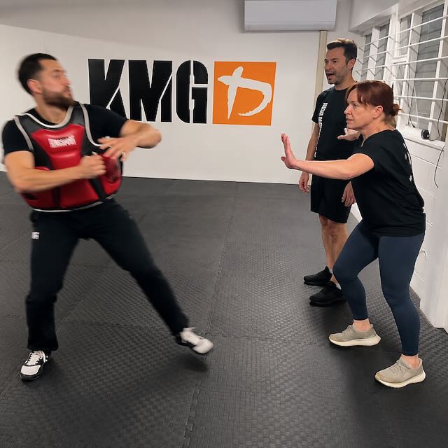 Krav Maga Auckland students practicing protective positioning during a third-party protection drill