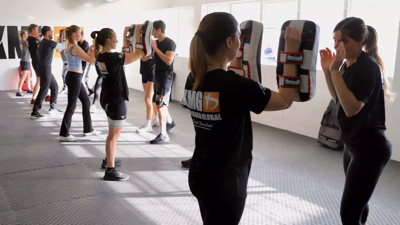Krav Maga Auckland class in action at Birkenhead, North Shore — mixed group drilling on pads