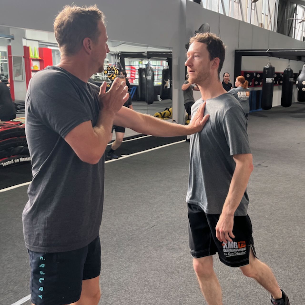 KMG New Zealand students training self-defence objectives in class