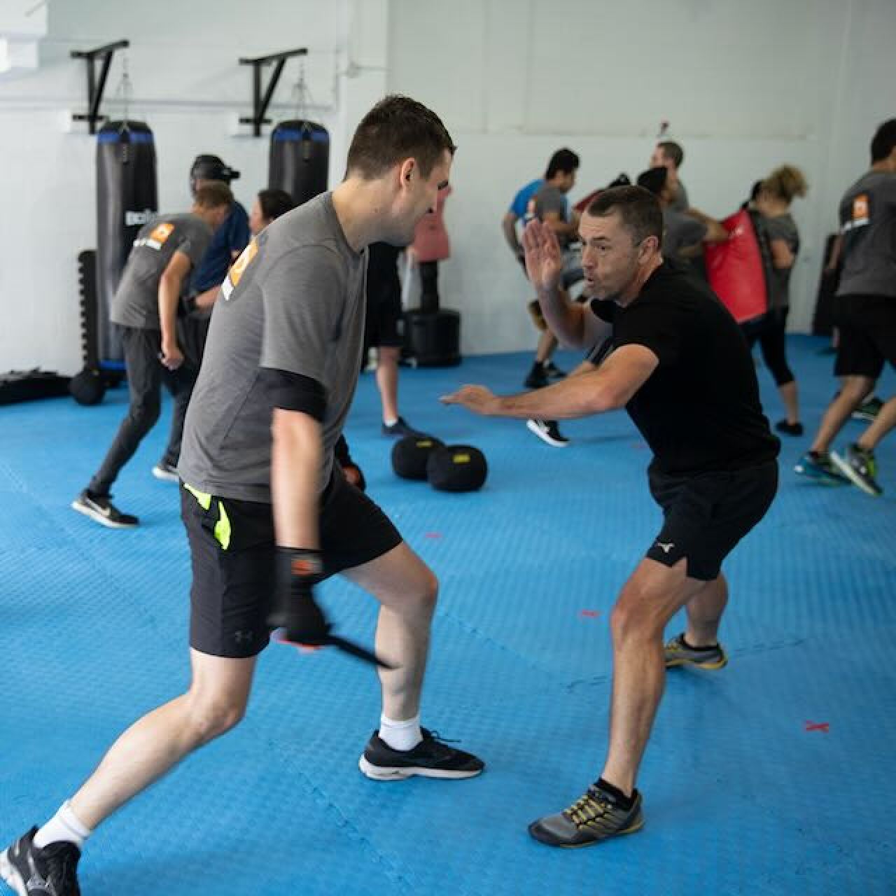 KMG instructor demonstrating knife defence awareness and response positioning during scenario training