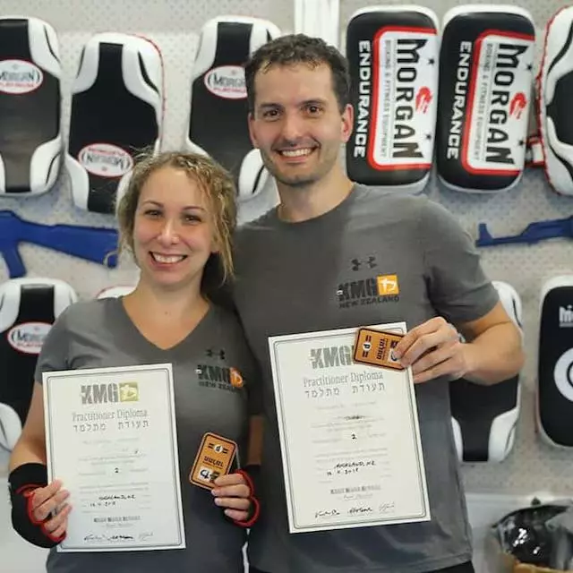 Krav Maga Auckland students Denisa and Jakub holding their KMG diplomas