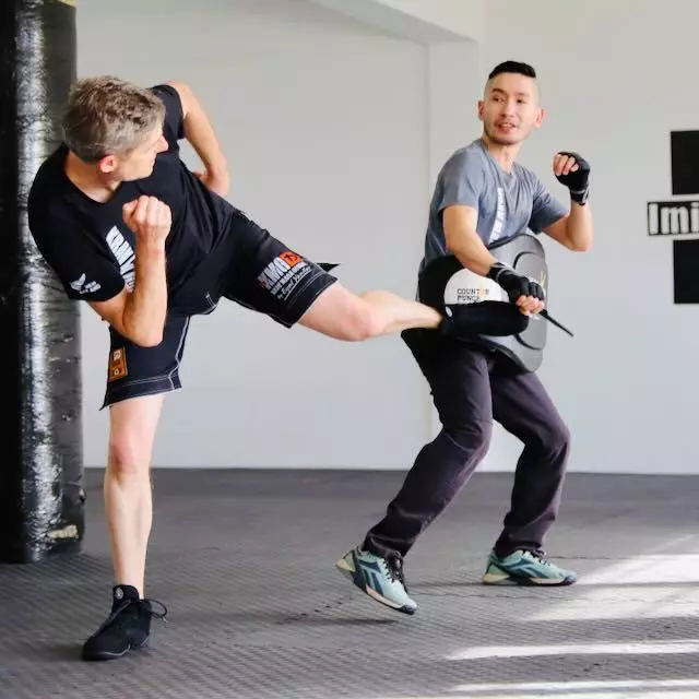 Krav Maga Auckland training a side kick against a knife threat — attacker uses a padded training knife. Not martial arts, not sport — practical self-defence.