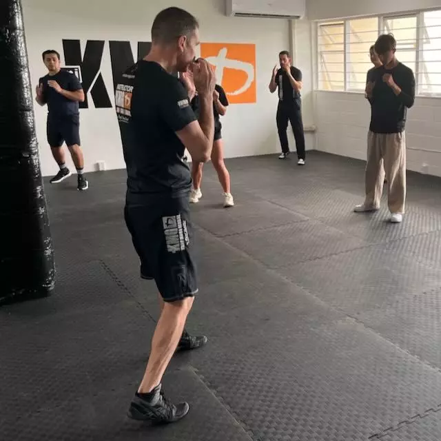 Instructor Aaron coaching a group of beginners through Krav Maga stances at Krav Maga Auckland in Birkenhead