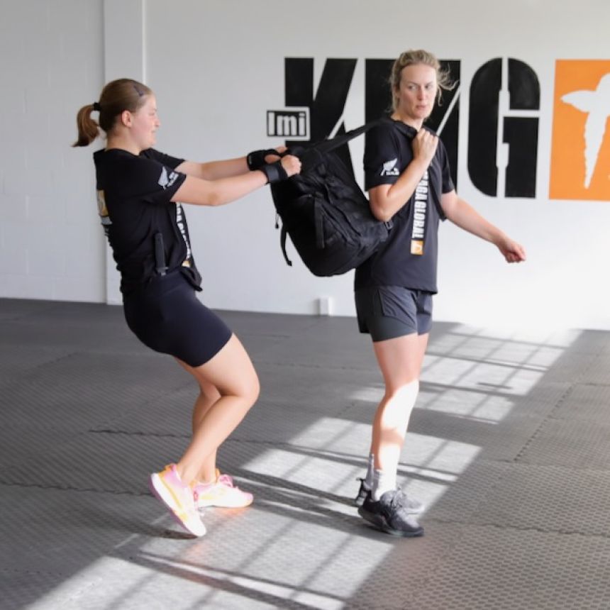 Krav Maga New Zealand student practising defence against a bag snatch from behind