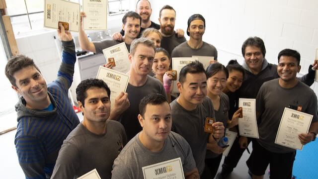 Krav Maga Auckland members receiving their Practitioner 1 grading diplomas